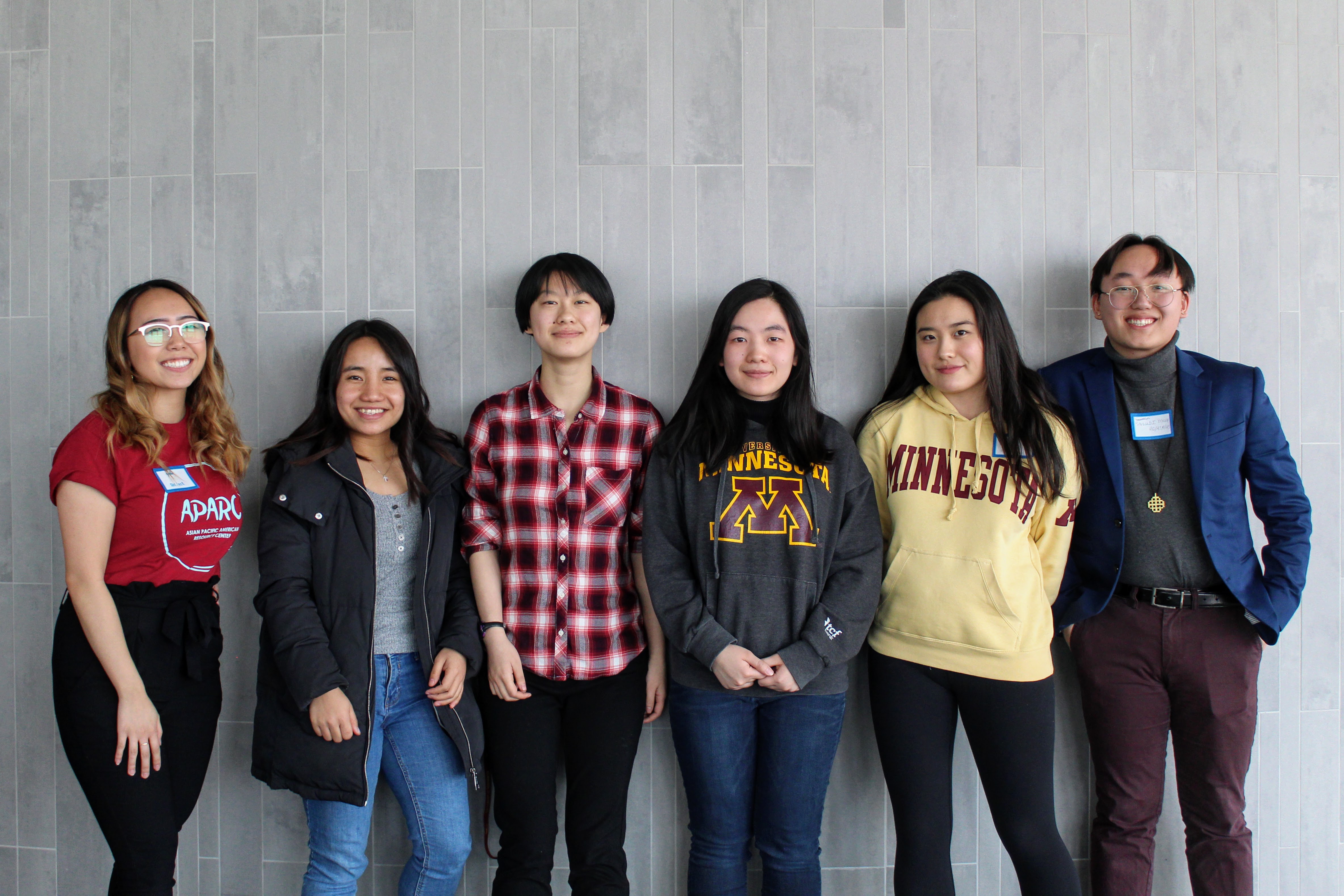 A group of six smiling Asian American college students. 